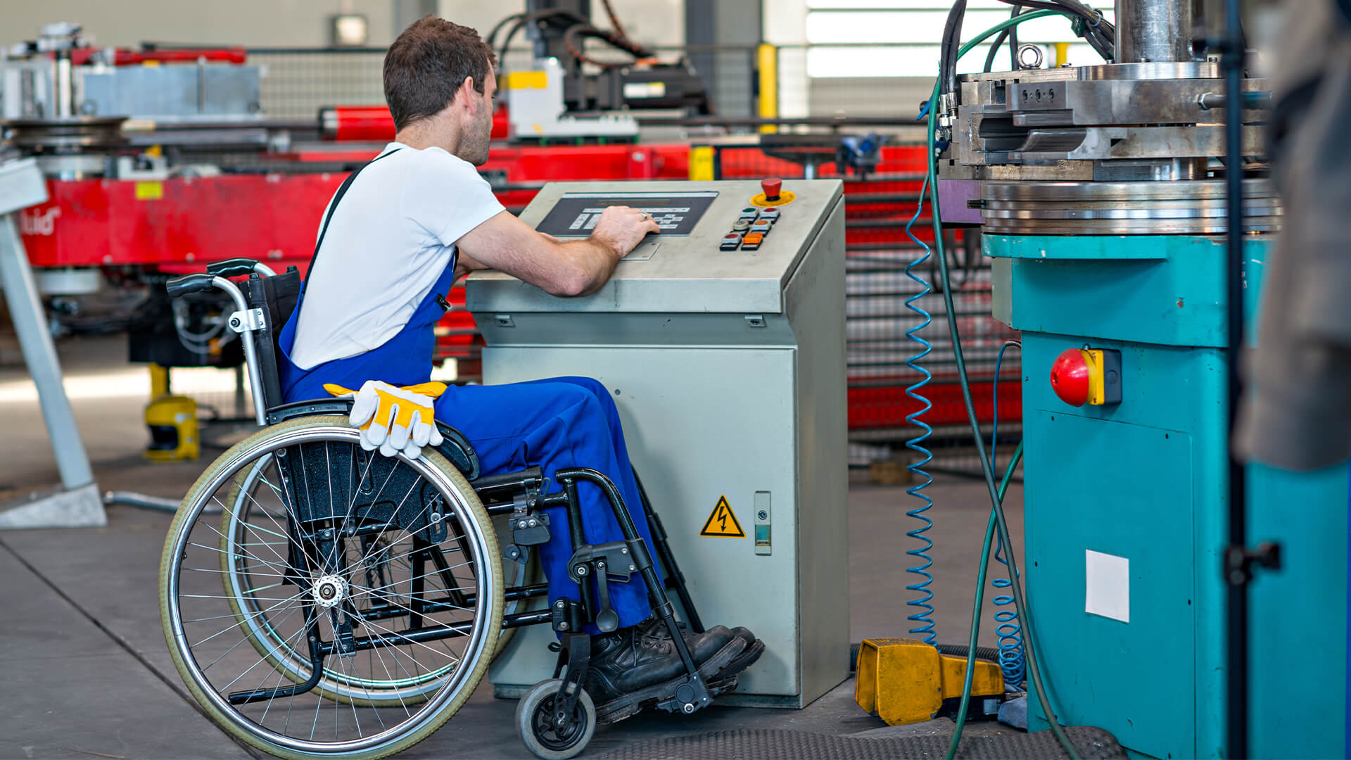 Disabled man working as an engineer in a factory