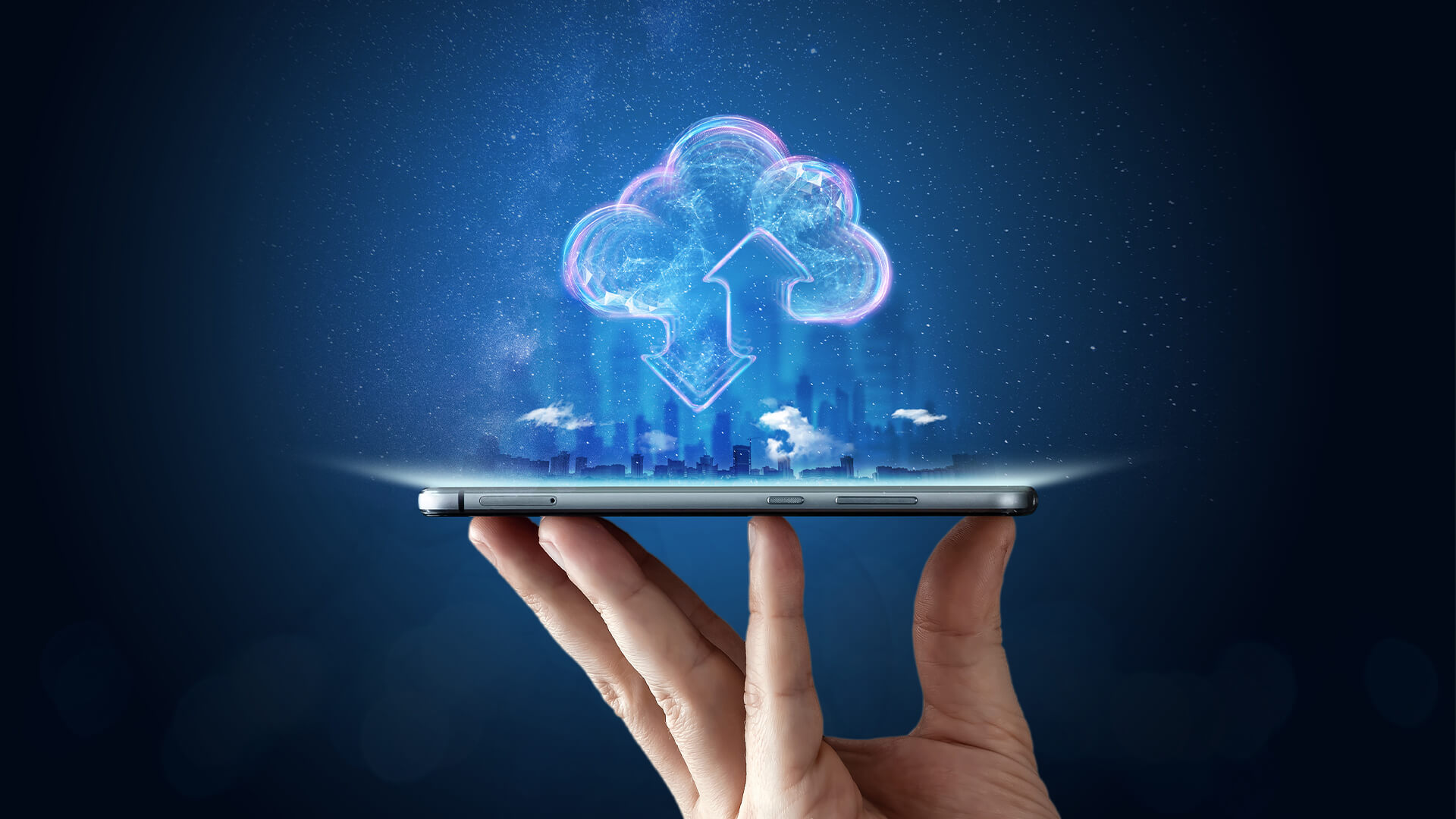 Hand holding up a tablet with digital clouds above it