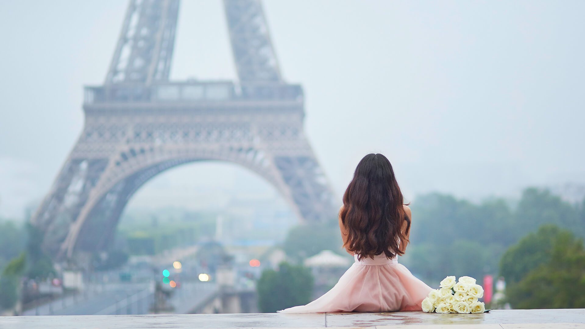 Women sitting near the Eiffel Tower in Paris