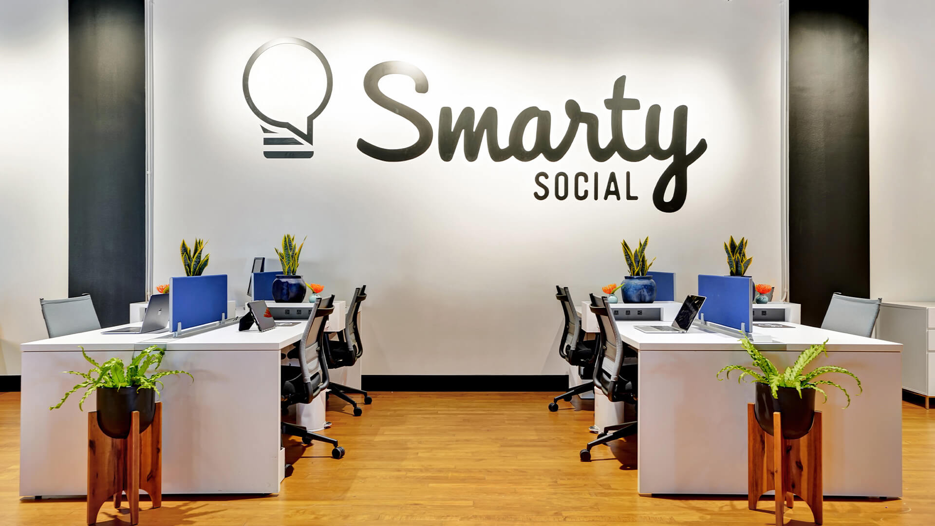 Office with Chairs and Computers and the Smarty Social Logo on the wall