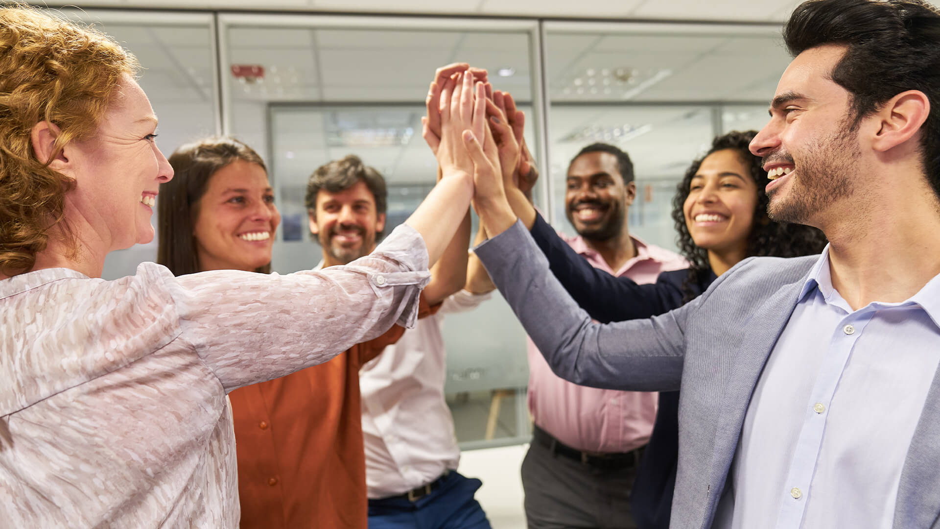 Successful business team makes high five in the office
