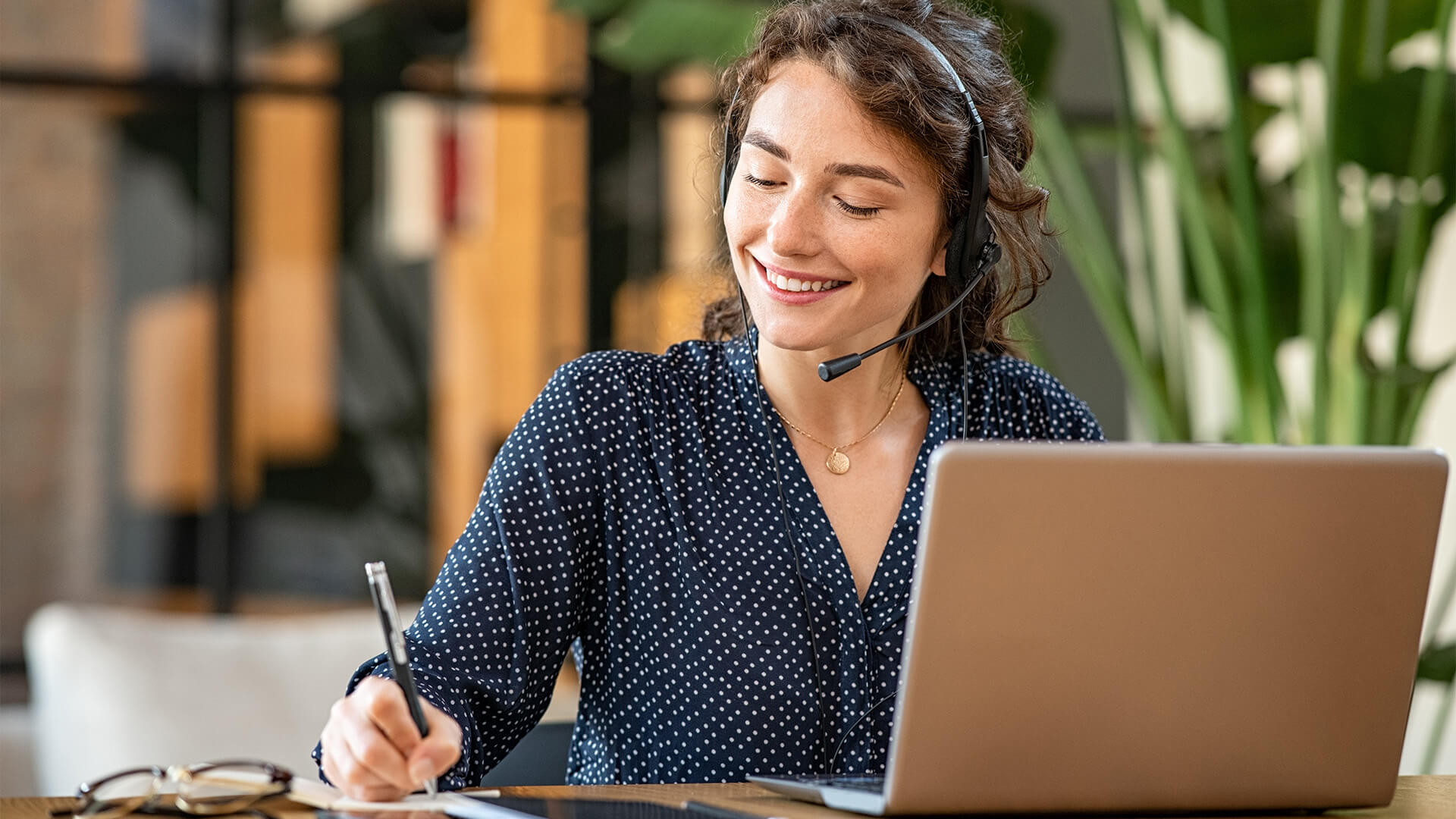 Successful customer service representative using laptop at office