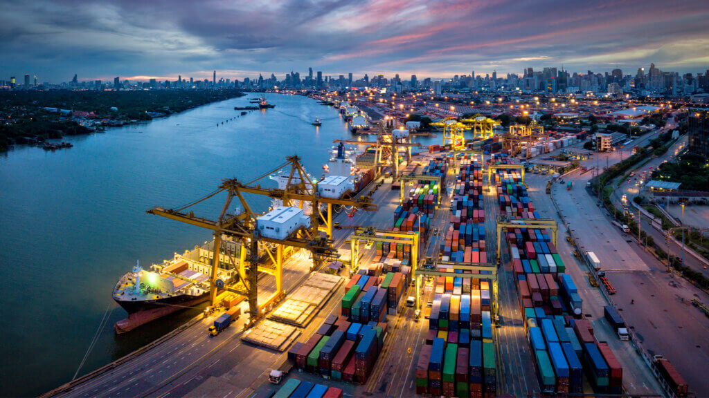 Aerial view of international port with Crane loading containers in import export business logistics