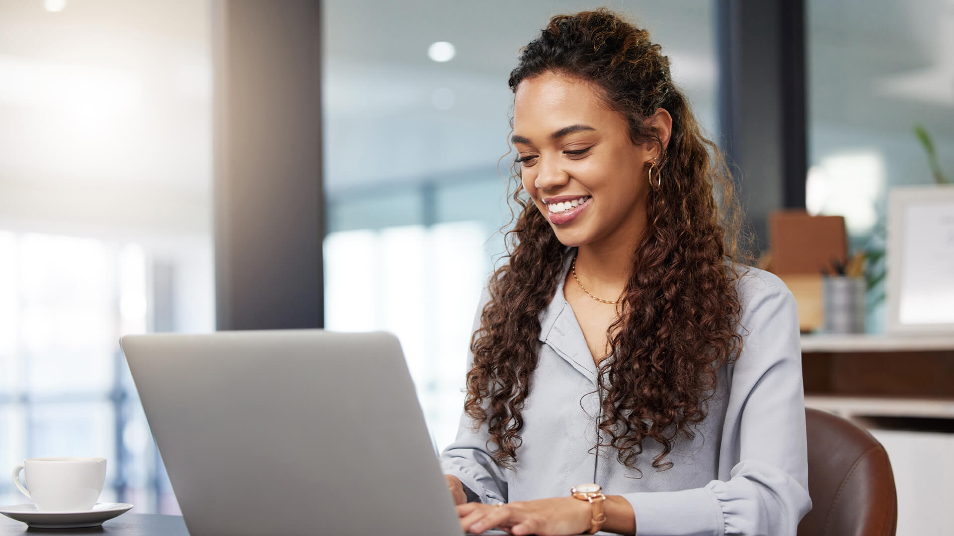 woman using laptop and smiling