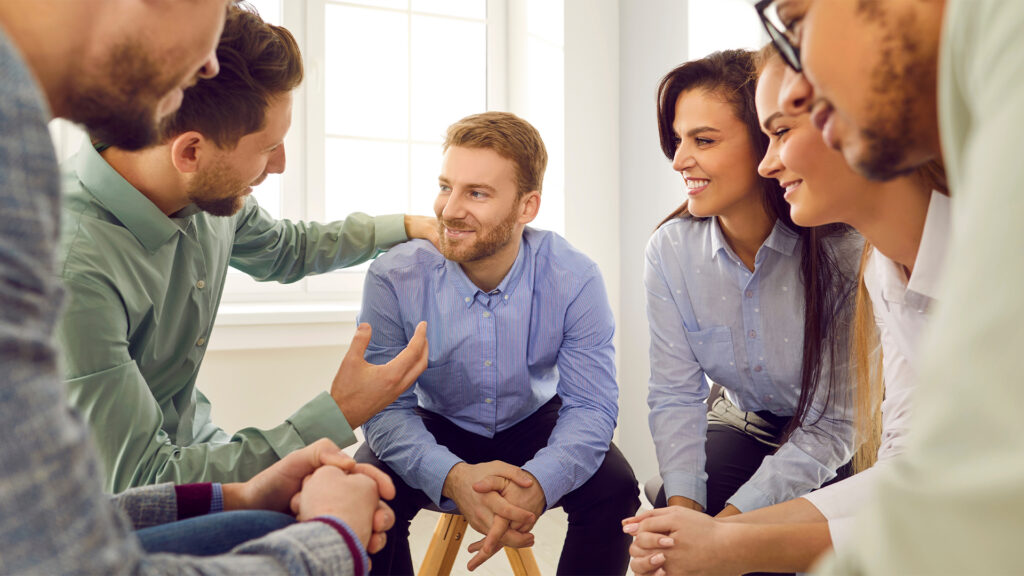 Group of people encouraging their friend