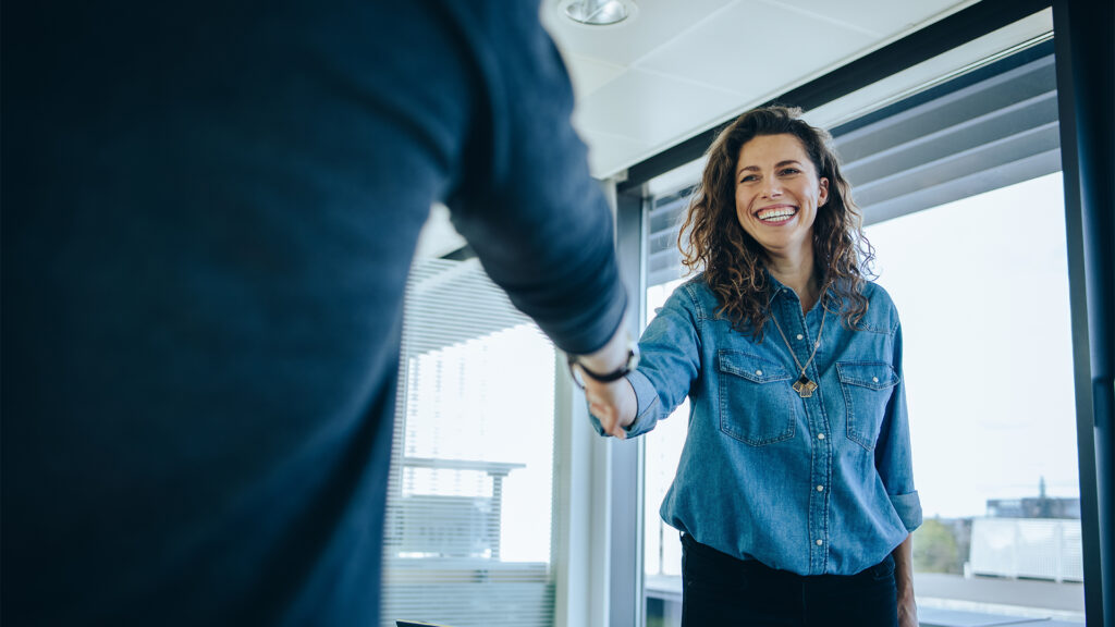 Businesswoman shaking hands with a job applicant